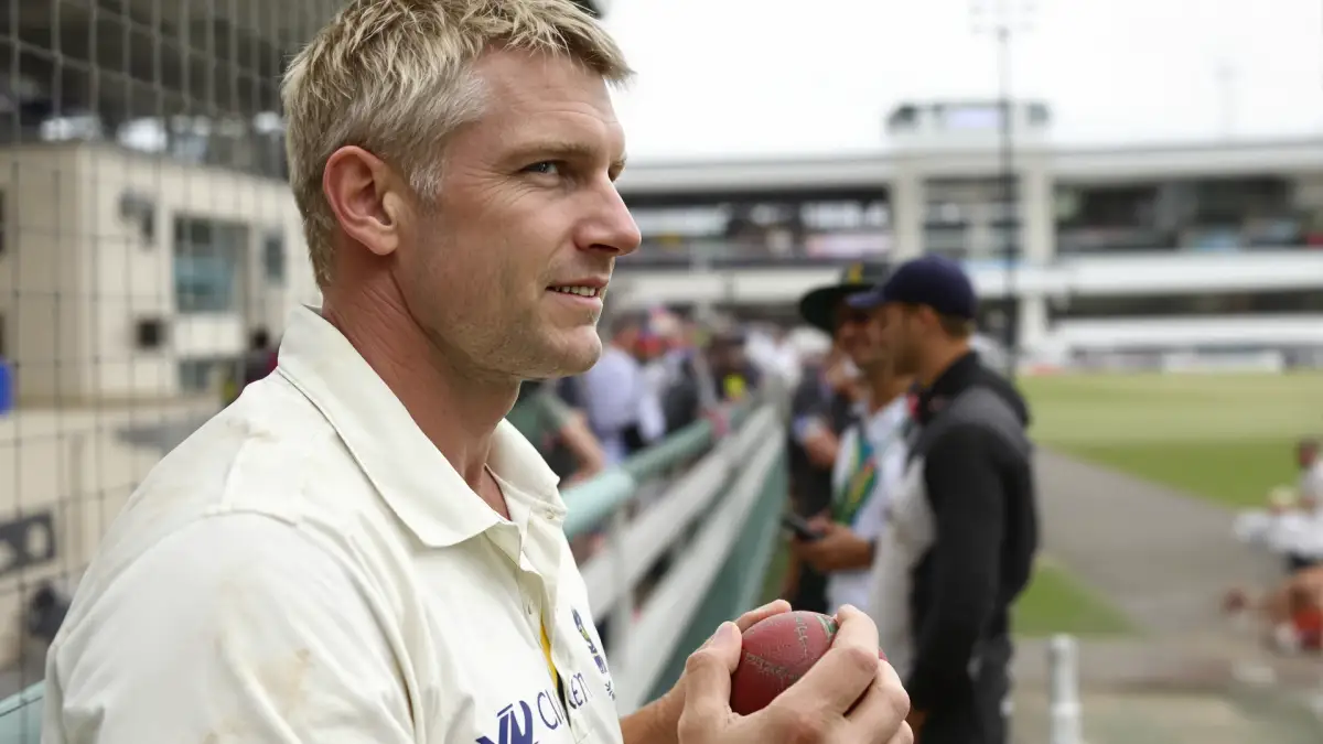 Illustrative photograph of a cricketer in whites on an overcast outfield
